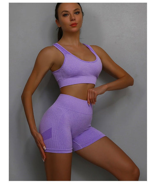 Woman wearing two-piece training shorts set during gym workout