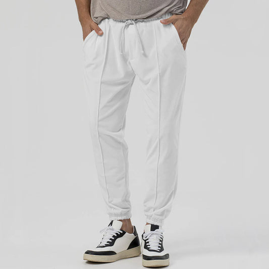 Men’s tapered casual joggers in white, front view.