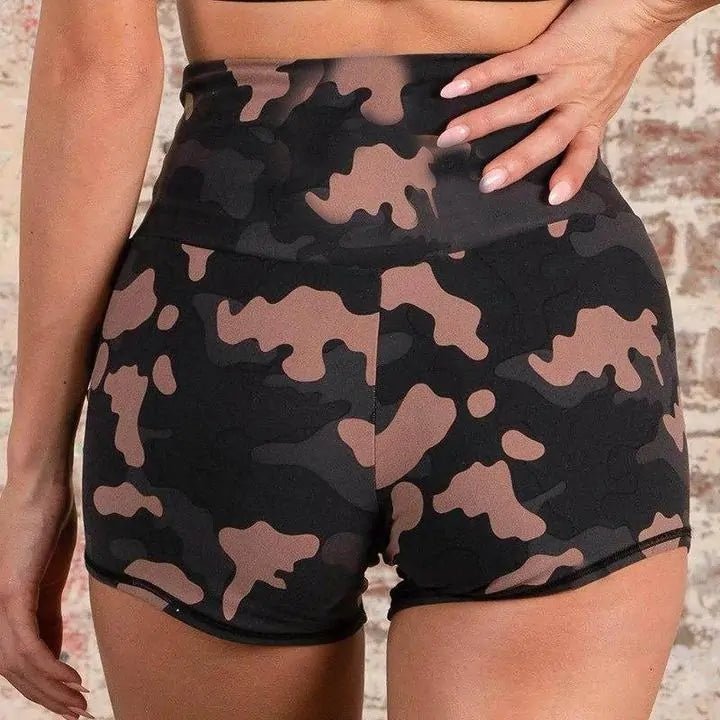 Woman wearing camo training shorts set during gym workout