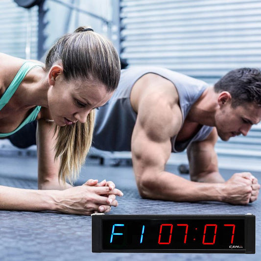 1-inch Electronic Countdown Training Timer with vibrant blue and red LED displays for outstanding visibility. Features an intuitive interface, infrared remote control, and durable aluminum design. Perfect for home, gym, or office workouts with wall-mount installation.- TNT Fitness Gear