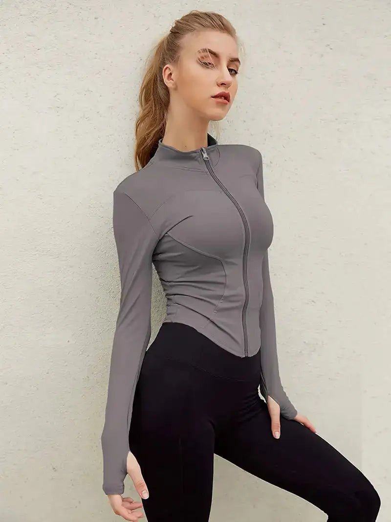 Women's lightweight zip-up yoga and workout jacket, designed for comfort and functionality. Made with breathable, stretchy fabric, this jacket offers a sleek fit and features a full zipper for easy layering. Perfect for yoga, workouts, or casual athleisure wear.- TNT Fitness Gear