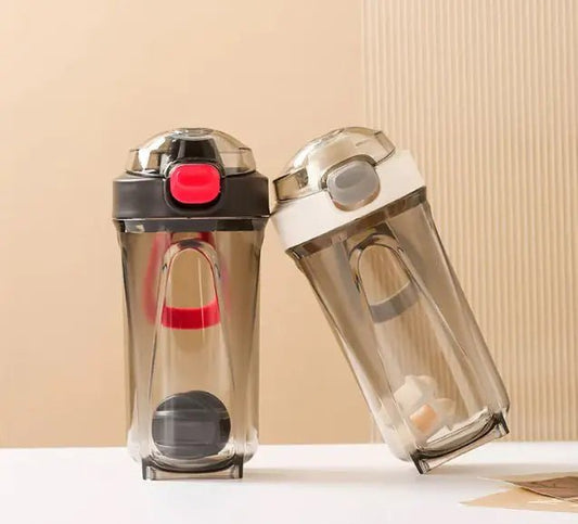 Fitness Shake Cup with a 32-ounce (950 ml) capacity, crafted from durable, BPA-free Tritan™ plastic. Features include a bounce cover for leak prevention, ergonomic non-slip grip, wide mouth for easy cleaning, integrated measurement markings, and a leak-proof seal. Portable, versatile, and dishwasher-safe, available in various colors.- TNT Fitness Gear