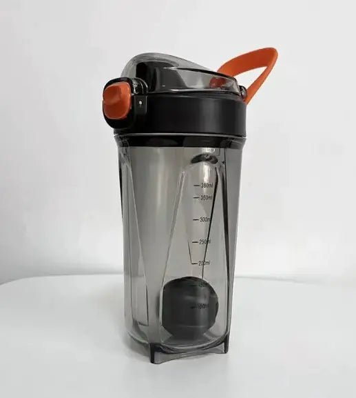 Fitness Shake Cup with a 32-ounce (950 ml) capacity, crafted from durable, BPA-free Tritan™ plastic. Features include a bounce cover for leak prevention, ergonomic non-slip grip, wide mouth for easy cleaning, integrated measurement markings, and a leak-proof seal. Portable, versatile, and dishwasher-safe, available in various colors.- TNT Fitness Gear