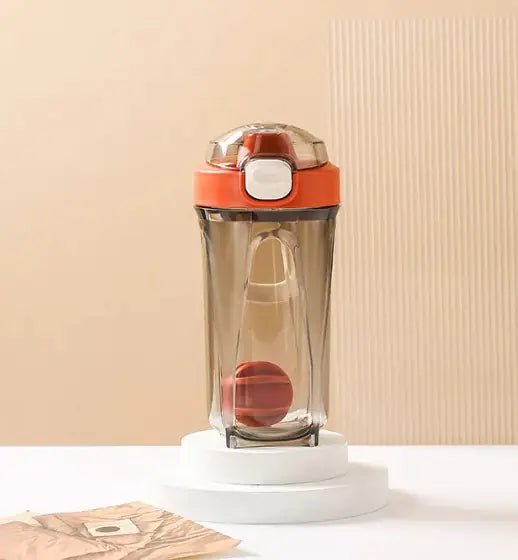 Fitness Shake Cup with a 32-ounce (950 ml) capacity, crafted from durable, BPA-free Tritan™ plastic. Features include a bounce cover for leak prevention, ergonomic non-slip grip, wide mouth for easy cleaning, integrated measurement markings, and a leak-proof seal. Portable, versatile, and dishwasher-safe, available in various colors.- TNT Fitness Gear