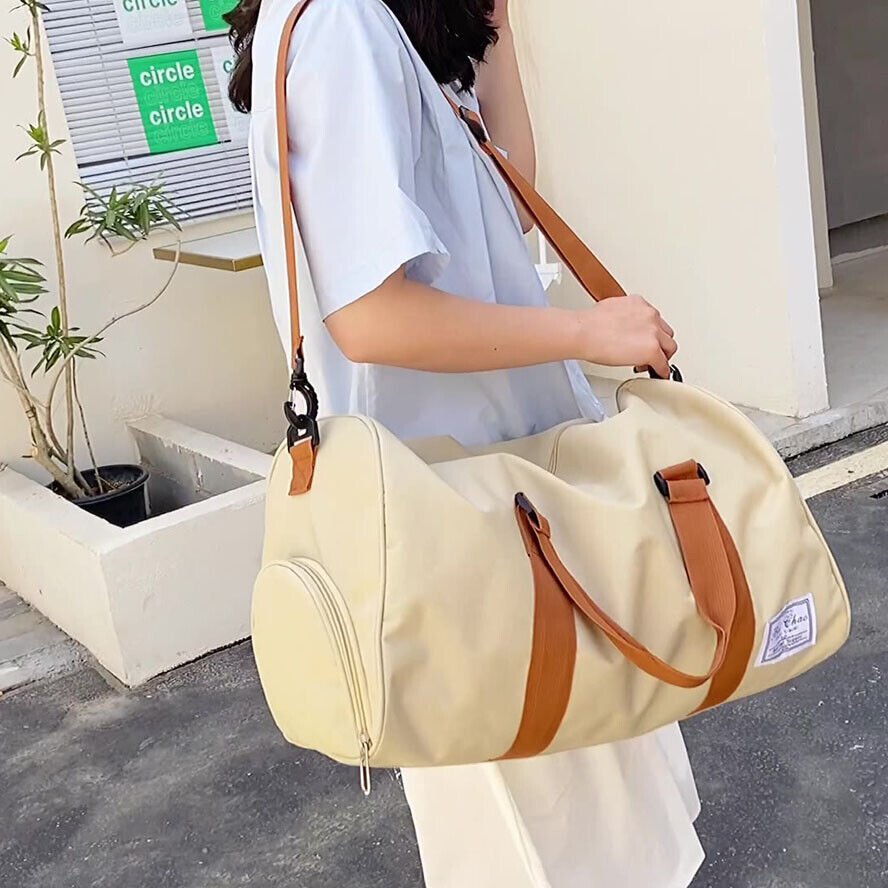 A durable and stylish large canvas training and travel bag with spacious compartments, breathable shoe pocket, and adjustable cushioned shoulder strap for convenience and versatility - TNT Fitness Gear