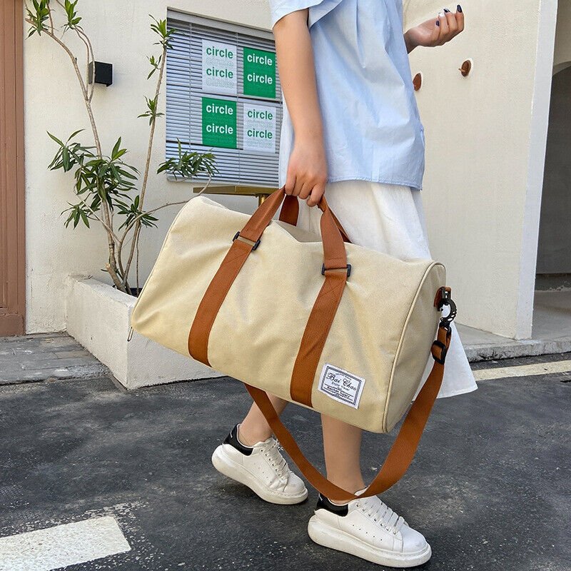 A durable and stylish large canvas training and travel bag with spacious compartments, breathable shoe pocket, and adjustable cushioned shoulder strap for convenience and versatility - TNT Fitness Gear