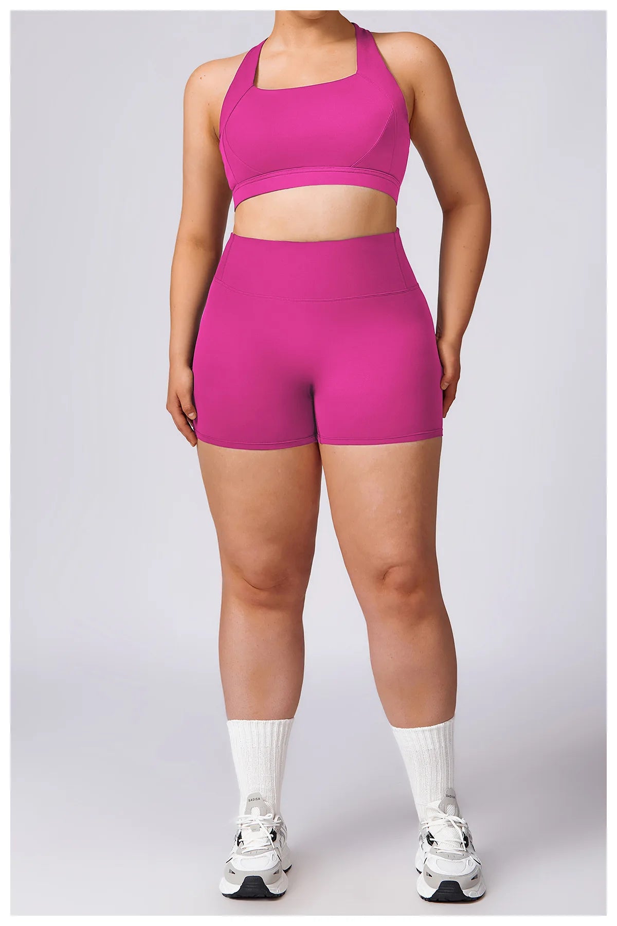 Plus-size woman wearing high-waisted performance training shorts during workout