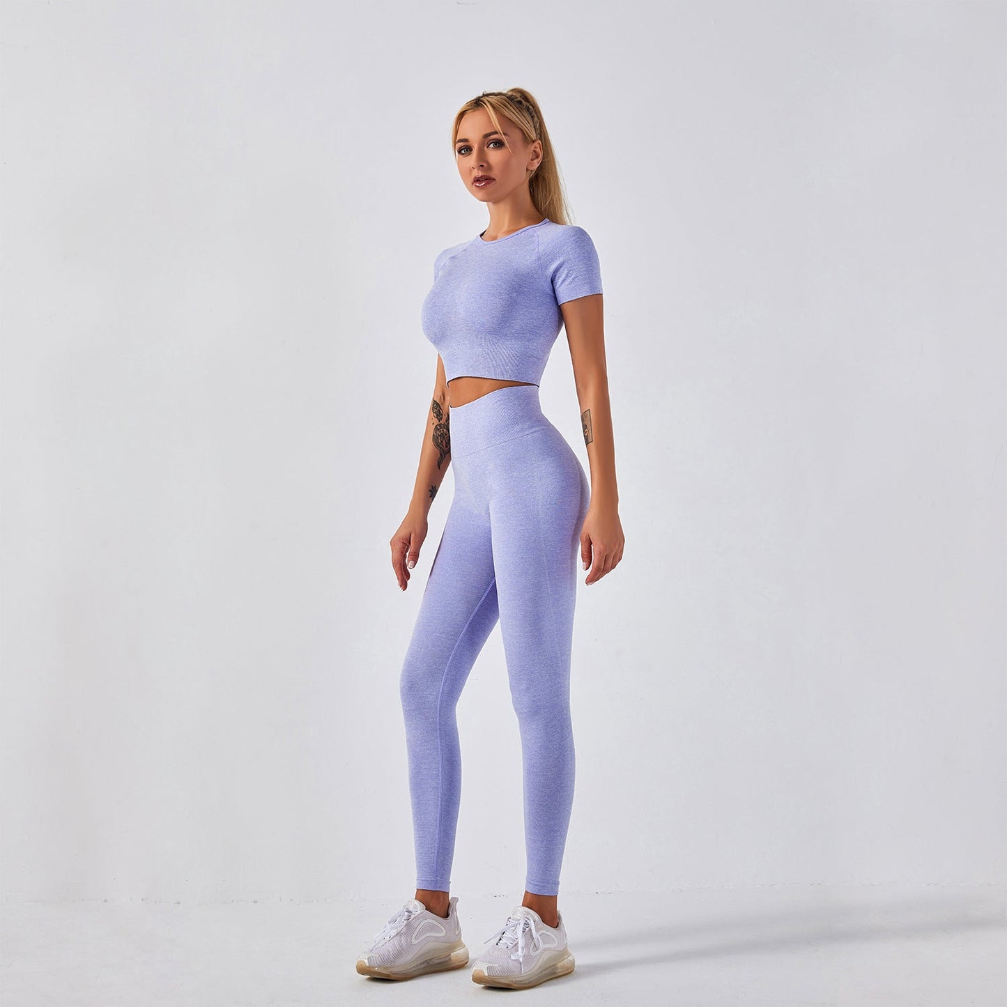 Women's seamless yoga set with short-sleeve top & trousers, in breathable nylon-spandex. Solid colors: hemp grey, pink, sky blue, orange, green, purple & red. By TNT Fitness Gear. Perfect for workouts