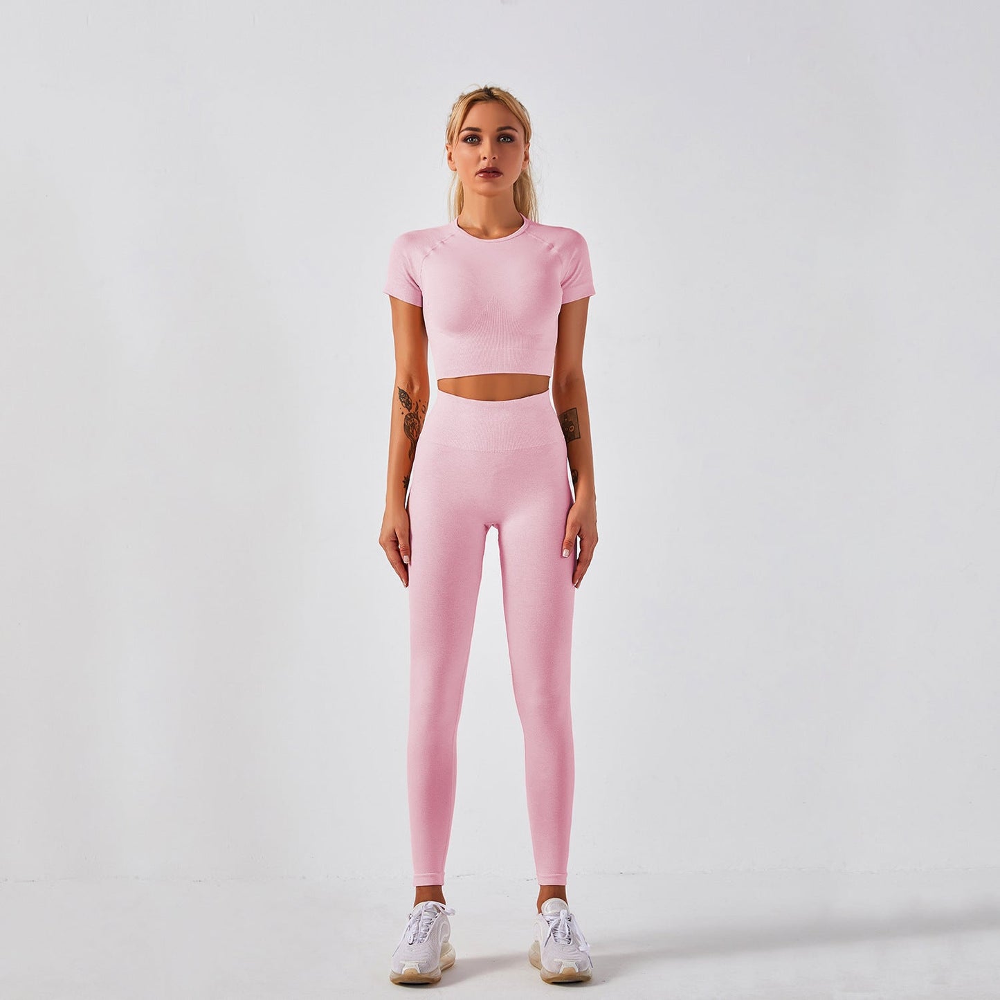 Women's seamless yoga set with short-sleeve top & trousers, in breathable nylon-spandex. Solid colors: hemp grey, pink, sky blue, orange, green, purple & red. By TNT Fitness Gear. Perfect for workouts
