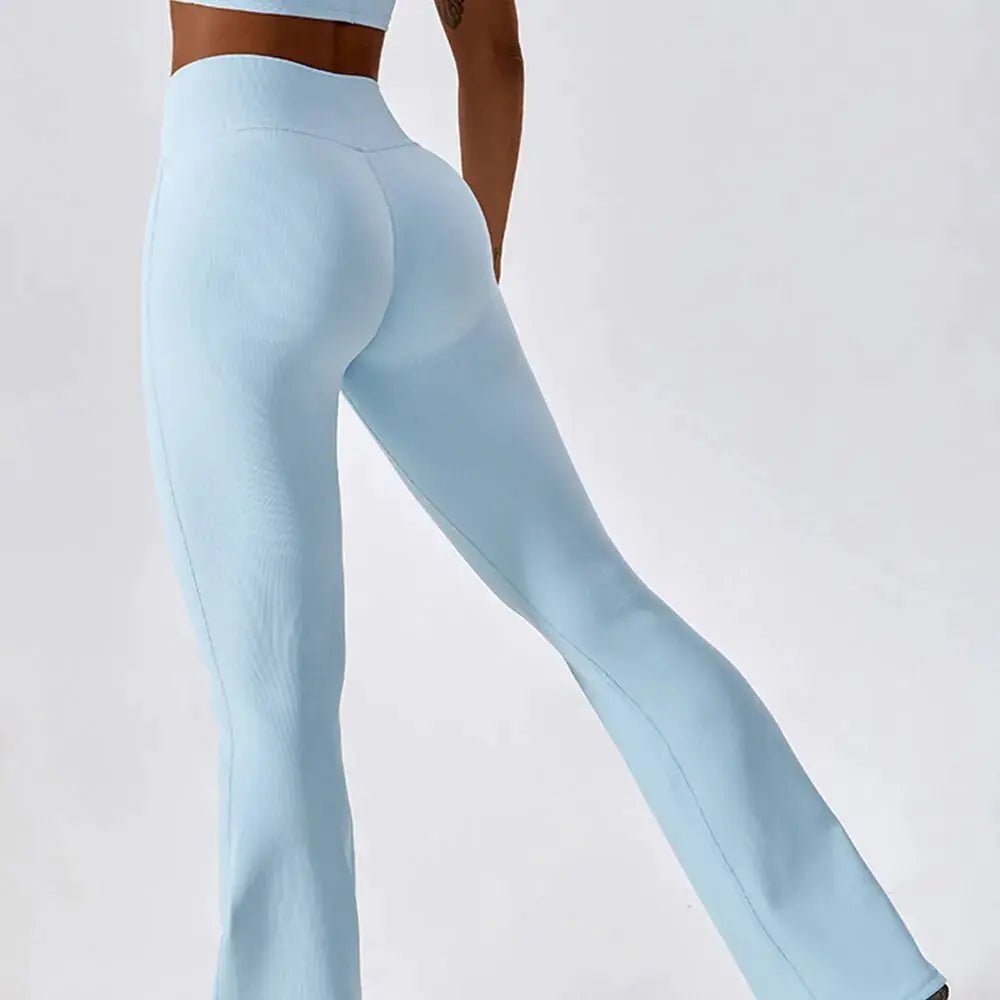 Flared fitness pants for women, designed for gym workouts and yoga. Made with stretchy, breathable material for comfort and freedom of movement. Features a flattering flared silhouette, ideal for both active and casual wear - TNT Fitness Gear