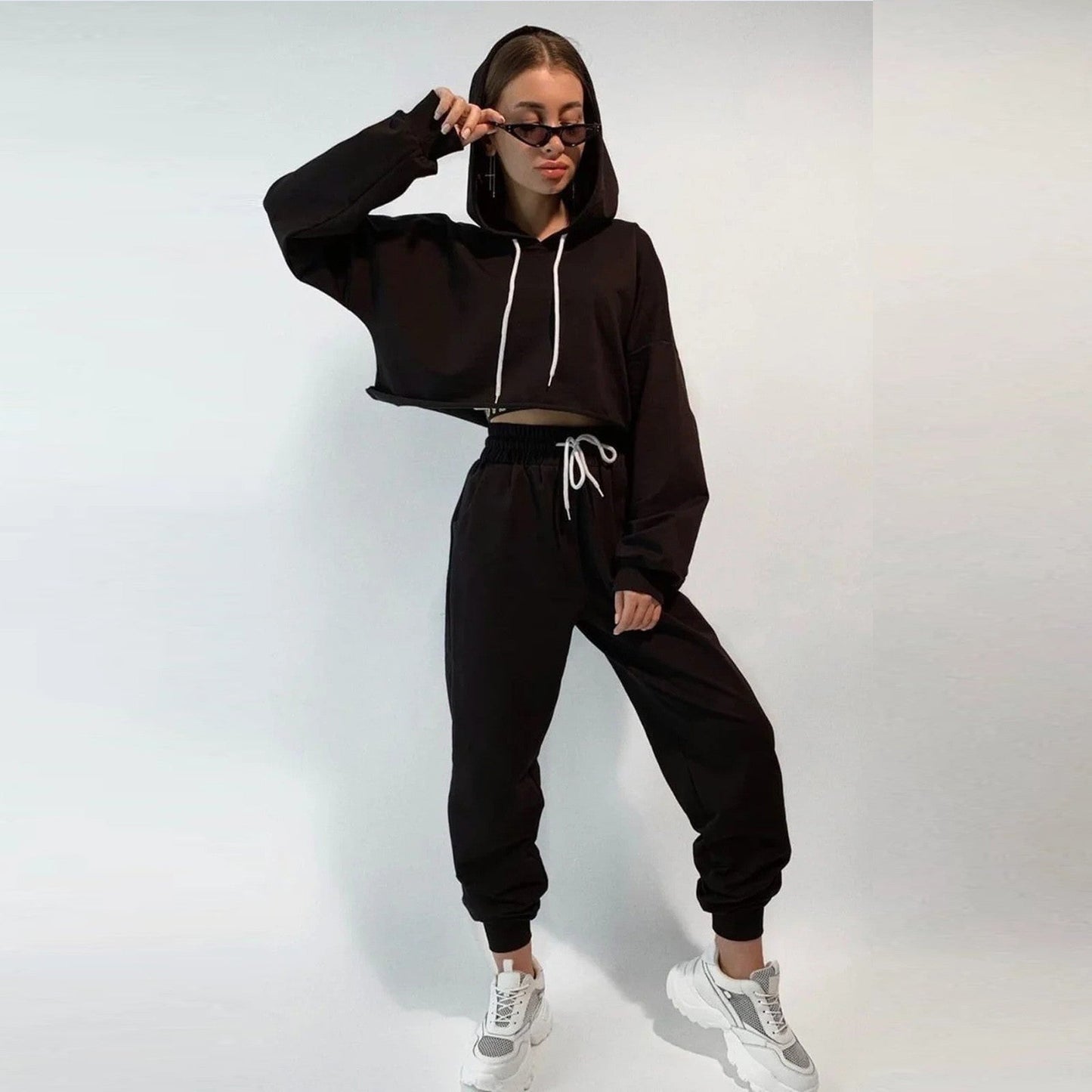 Women's comfortable sports and leisure suits displayed in various neutral and pastel tones, designed for versatility and style. The outfits combine relaxed fits with breathable fabrics, perfect for workouts, casual outings, or lounging. Features include stretchy waistbands, soft-touch materials, and modern cuts to ensure comfort and functionality - TNT Fitness Gear