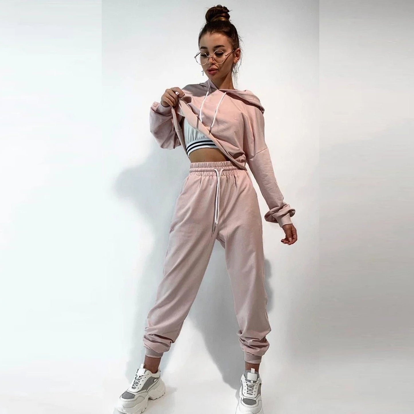 Women's comfortable sports and leisure suits displayed in various neutral and pastel tones, designed for versatility and style. The outfits combine relaxed fits with breathable fabrics, perfect for workouts, casual outings, or lounging. Features include stretchy waistbands, soft-touch materials, and modern cuts to ensure comfort and functionality - TNT Fitness Gear