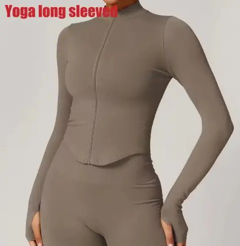 Women's zippered fitness crop top designed for style and functionality. Featuring a sleek zipper detail and a flattering cropped fit, this top is made from breathable, stretchy fabric for comfort and flexibility. Ideal for workouts, yoga, or trendy athleisure wear - TNT Fitness