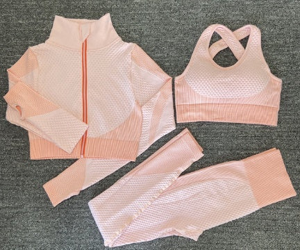 Pink women’s matching workout set with sports bra leggings and jacket