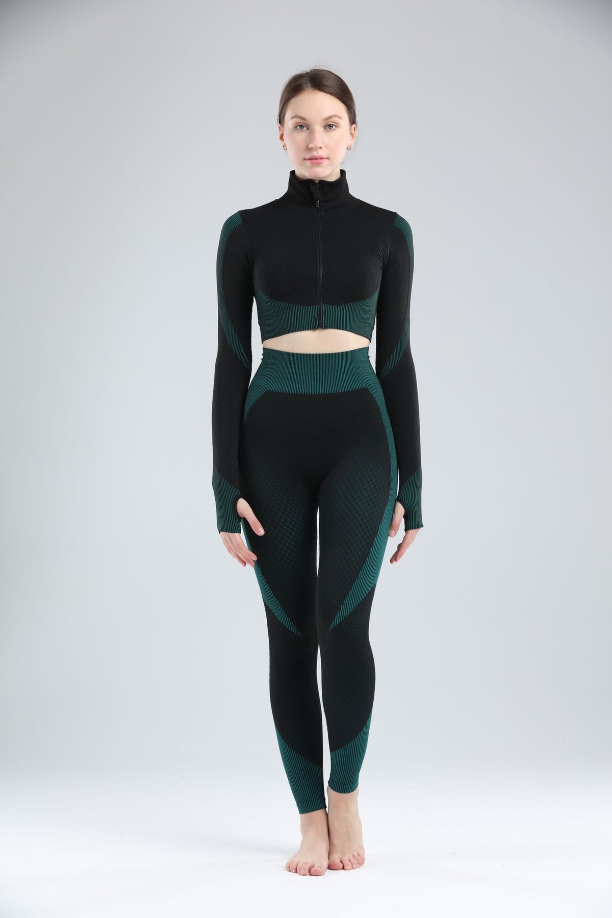 Black and green women’s long sleeve workout jacket and matching activewear