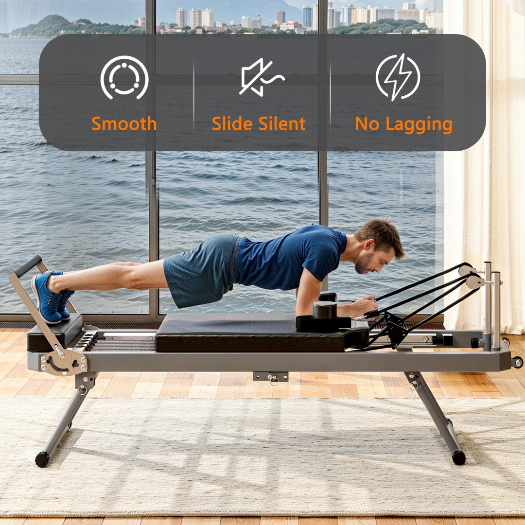 A man using a Pilates reformer machine with a view of water and cityscape in the background- TNT Fitness Gear