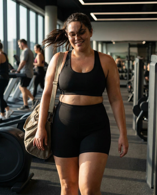Plus-size woman wearing high-waisted performance training shorts during workout