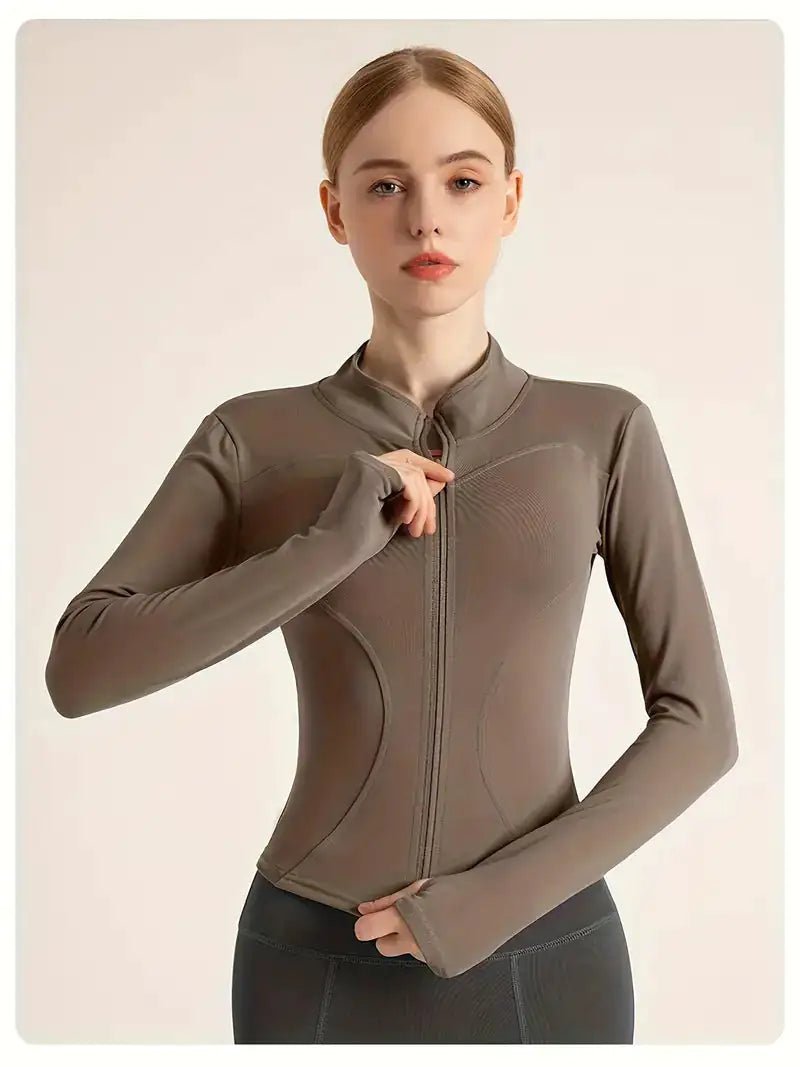 Women's lightweight zip-up yoga and workout jacket, designed for comfort and functionality. Made with breathable, stretchy fabric, this jacket offers a sleek fit and features a full zipper for easy layering. Perfect for yoga, workouts, or casual athleisure wear.- TNT Fitness Gear