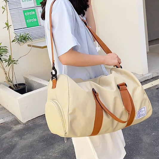 A durable and stylish large canvas training and travel bag with spacious compartments, breathable shoe pocket, and adjustable cushioned shoulder strap for convenience and versatility  - TNT Fitness Gear